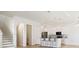Modern kitchen featuring white cabinets, stainless steel appliances, and a breakfast bar with seating at 11594 Oak Ln, Largo, FL 33778