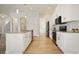Well-equipped kitchen boasts stainless steel appliances, white cabinets, an island, and modern lighting at 11594 Oak Ln, Largo, FL 33778