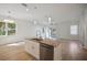 Kitchen island featuring a sink, granite countertops, and stainless-steel dishwasher at 11594 Oak Ln, Largo, FL 33778