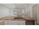 Kitchen island featuring a sink, granite countertops, and stainless-steel dishwasher at 11594 Oak Ln, Largo, FL 33778