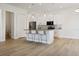 Open-concept kitchen featuring white cabinets, granite countertops, stainless steel appliances, and bar seating at 11594 Oak Ln, Largo, FL 33778