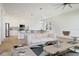 Bright and open living room with modern furniture, flowing into a kitchen with a large island at 11594 Oak Ln, Largo, FL 33778