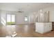 Bright living room featuring a ceiling fan, wood flooring, and sliding glass doors to the outside at 11594 Oak Ln, Largo, FL 33778