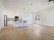 Bright and open living space featuring a modern kitchen with an island and stainless steel appliances at 11594 Oak Ln, Largo, FL 33778