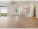 Bright, open-concept living area featuring hardwood floors, a modern ceiling fan, and sliding glass doors at 11594 Oak Ln, Largo, FL 33778