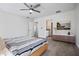 Spacious main bedroom with carpet flooring, ensuite bathroom, and a window view of mature trees at 11594 Oak Ln, Largo, FL 33778
