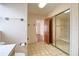 Bathroom with mirrored closet, beige tile floor, and doorway to another room at 3530 25Th N Ave, St Petersburg, FL 33713
