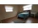 Comfortable bedroom with wood-look flooring and bright natural light from two windows at 3530 25Th N Ave, St Petersburg, FL 33713