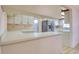 Open kitchen design with white cabinets, bar top, stainless steel refrigerator, and tile flooring at 3530 25Th N Ave, St Petersburg, FL 33713