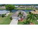 Aerial view showcasing a home on the water with a well-maintained lawn at 609 Fort Duquesna Dr, Sun City Center, FL 33573