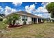 Backyard area with lush green lawn and palm tree accents at 609 Fort Duquesna Dr, Sun City Center, FL 33573