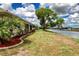 Backyard area with lush green lawn extends to the canal at 609 Fort Duquesna Dr, Sun City Center, FL 33573