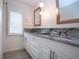 Beautiful bathroom boasts granite countertops, dual sinks, and modern fixtures at 609 Fort Duquesna Dr, Sun City Center, FL 33573