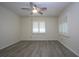 Spacious bedroom with ceiling fan, hard wood flooring, and plantation shutters at 609 Fort Duquesna Dr, Sun City Center, FL 33573