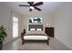 Comfortable bedroom features a ceiling fan and shuttered windows for optimal lighting control at 609 Fort Duquesna Dr, Sun City Center, FL 33573