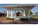 Charming white gazebo with a view of the Community Hall across a manicured lawn at 609 Fort Duquesna Dr, Sun City Center, FL 33573
