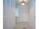 Bright entryway with tile flooring, a storage closet, and a stylish light fixture at 609 Fort Duquesna Dr, Sun City Center, FL 33573