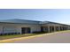Sun City Center Arts and Crafts building with a blue metal roof and well-manicured landscaping at 609 Fort Duquesna Dr, Sun City Center, FL 33573