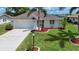 Charming home featuring well-manicured lawn, palm trees, and a two-car garage at 609 Fort Duquesna Dr, Sun City Center, FL 33573