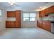 Eat-in kitchen featuring wood cabinets, tile floors, and a large window at 609 Fort Duquesna Dr, Sun City Center, FL 33573