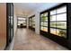 Extended lanai with tile flooring and peaceful views of the surrounding pond at 609 Fort Duquesna Dr, Sun City Center, FL 33573