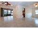 Open living room with tile flooring, vaulted ceilings, and access to the kitchen at 609 Fort Duquesna Dr, Sun City Center, FL 33573
