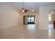 Spacious living room with tile flooring, vaulted ceiling, and sliding glass doors to the lanai at 609 Fort Duquesna Dr, Sun City Center, FL 33573