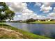 Scenic waterfront view of homes along a canal in a tranquil community with a beautiful blue sky at 609 Fort Duquesna Dr, Sun City Center, FL 33573