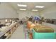 Bright workshop featuring organized work stations with various equipment, cabinets, and ample lighting for crafting at 609 Fort Duquesna Dr, Sun City Center, FL 33573