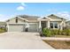 Charming single-Gathering home with a three-car garage, stone accents, and well-maintained landscaping at 6189 Hidden Branch Dr, Apollo Beach, FL 33572