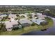 An aerial view of waterfront homes featuring screened-in pools and lush landscaping at 10626 Restoration Ter, Bradenton, FL 34212