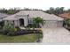 Aerial view of home's front yard, driveway, and three-car garage at 10626 Restoration Ter, Bradenton, FL 34212