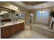 Spacious bathroom with double vanity, shower, garden tub, and large windows at 10626 Restoration Ter, Bradenton, FL 34212