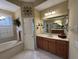 Bathroom features double vanity, garden tub, walk-in shower, and neutral tiling at 10626 Restoration Ter, Bradenton, FL 34212