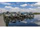 Several boats docked at a marina with a wood pier reflecting on tranquil water at 10626 Restoration Ter, Bradenton, FL 34212