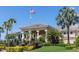 The community clubhouse is framed with beautiful tropical landscaping and an American flag at 10626 Restoration Ter, Bradenton, FL 34212