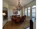 Formal dining room with a chandelier and view of the kitchen at 10626 Restoration Ter, Bradenton, FL 34212