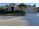 Charming single-story home featuring a well-manicured front lawn and three-car garage at 10626 Restoration Ter, Bradenton, FL 34212