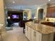 Open-concept kitchen flows into the living area, featuring a large island with barstool seating at 10626 Restoration Ter, Bradenton, FL 34212