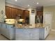 The kitchen has stainless steel appliances and an island with granite countertops and seating at 10626 Restoration Ter, Bradenton, FL 34212