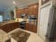 Modern kitchen featuring stainless steel appliances, granite counters, and wood cabinets at 10626 Restoration Ter, Bradenton, FL 34212