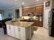 Gourmet kitchen featuring an island with granite countertops, stainless appliances, and lots of storage at 10626 Restoration Ter, Bradenton, FL 34212