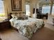 Spacious main bedroom with tropical bedding, decorative columns, and a large dresser at 10626 Restoration Ter, Bradenton, FL 34212