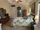 Bright main bedroom with decorative pillars, a large dresser, and a view into the ensuite bathroom at 10626 Restoration Ter, Bradenton, FL 34212