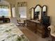 Relaxing main bedroom with decorative furniture, columns, and beautiful natural light from the window at 10626 Restoration Ter, Bradenton, FL 34212