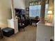 Home office featuring a built-in desk, decorative columns, and ample natural light for a productive workspace at 10626 Restoration Ter, Bradenton, FL 34212