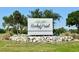 Community entrance sign with tropical landscaping and attractive stone accents at 3909 W Eden Roc Cir, Tampa, FL 33634