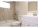 Stylish bathroom featuring tiled shower-tub combination and white vanity with modern fixtures at 7160 Lenape Cir, New Port Richey, FL 34653