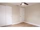 A bedroom with light wood floors and a closet featuring sliding doors at 7160 Lenape Cir, New Port Richey, FL 34653