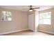 Bedroom with light wood floors, neutral paint, closet and view from two windows at 7160 Lenape Cir, New Port Richey, FL 34653